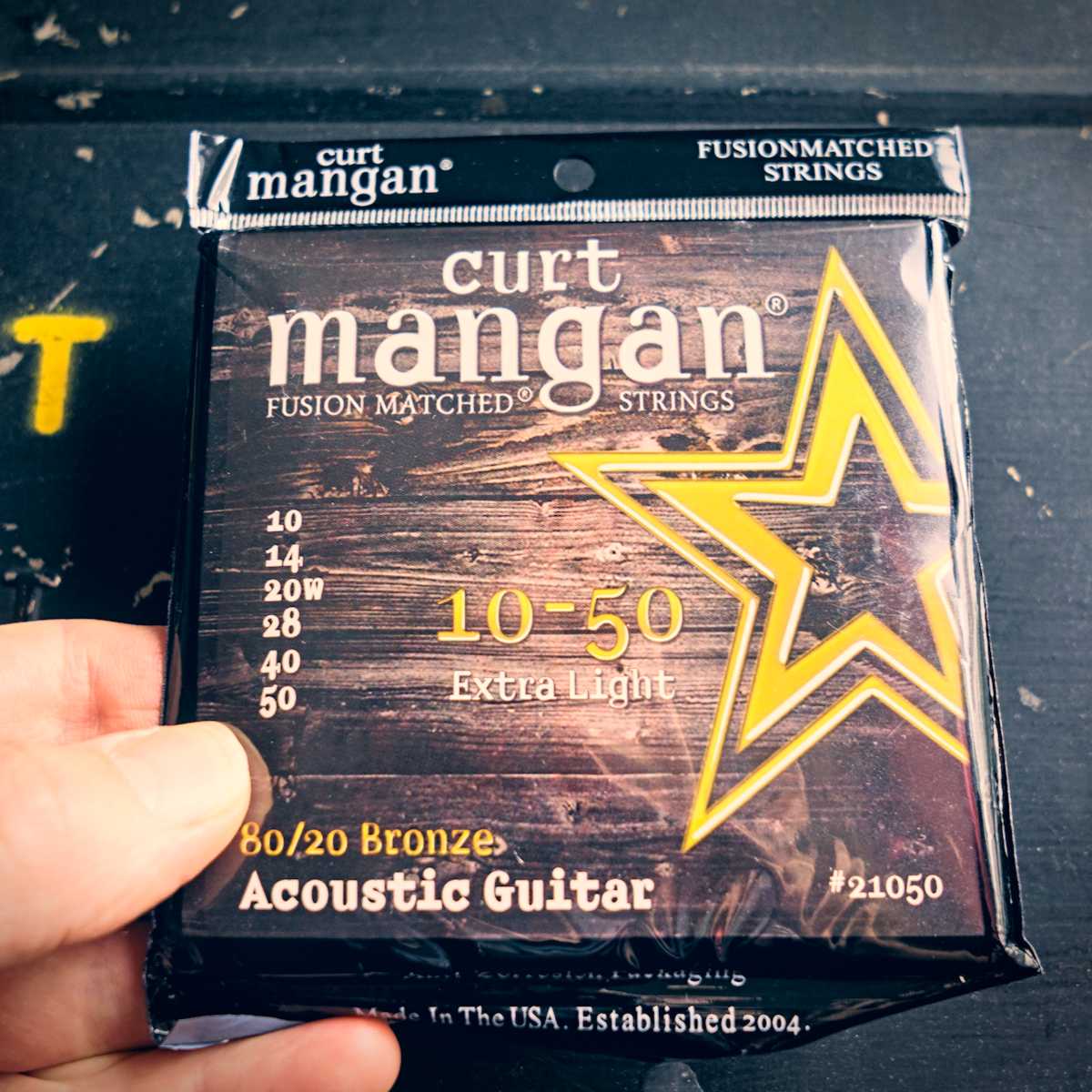 A set of Curt Mangan 80/20 acoustic guitar strings for fingerstyle guitar, one of the best for fingerpicking